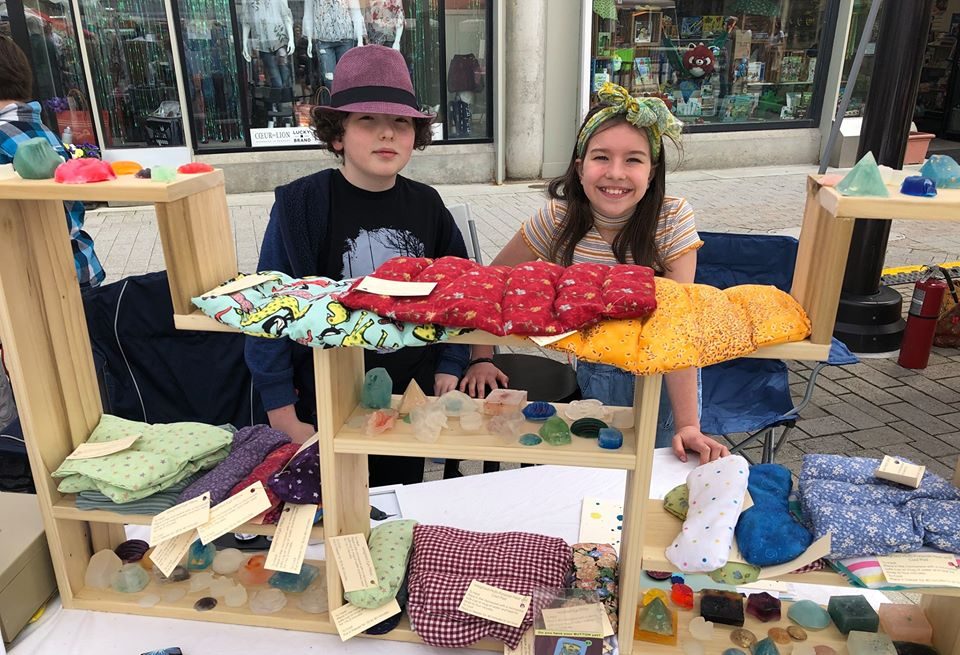 Two students selling handmade neck wraps at the 2019 Youth Entrepreneurship Market.